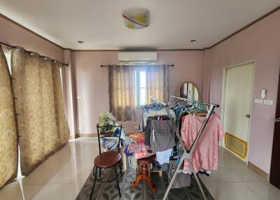 Bedroom with clothes rack and curtains