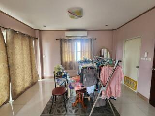 Bedroom with clothes rack and curtains