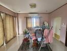 Bedroom with clothes rack and curtains