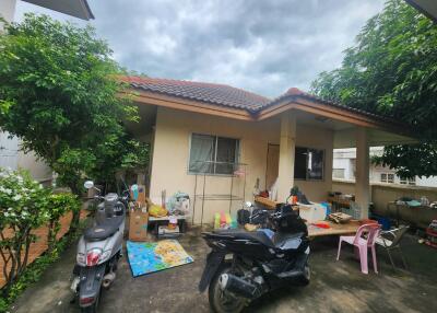 Exterior view of a building with motorbikes and outdoor items