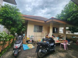 Exterior view of a building with motorbikes and outdoor items