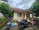 Exterior view of a building with motorbikes and outdoor items