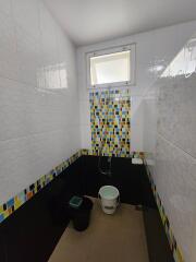 Bathroom with colorful tile accents and window