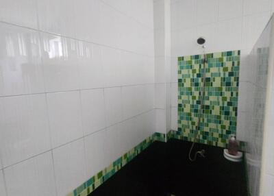 Bathroom with shower and mosaic tiles