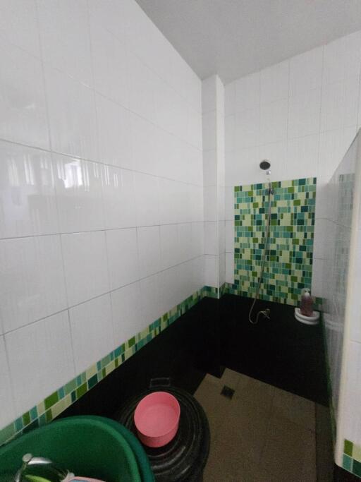 Bathroom with shower and mosaic tiles