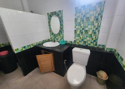 Modern bathroom with tiled backsplash and stylish features