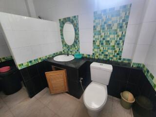 Modern bathroom with tiled backsplash and stylish features