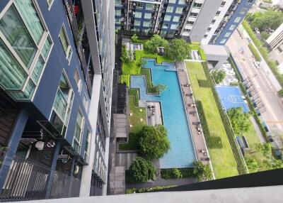 High-rise apartment view with swimming pool and basketball court