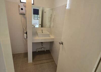 Small bathroom with sink and water heater