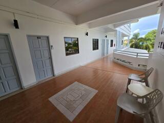 Hallway with doors, windows, and chairs