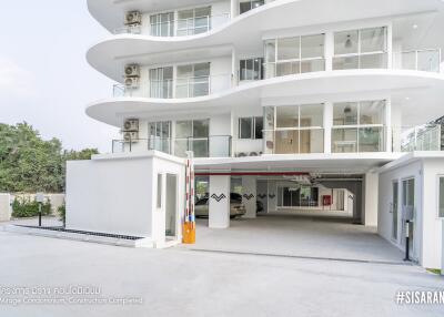 Modern white multi-story condominium with balconies