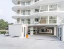 Modern white multi-story condominium with balconies