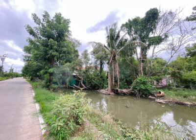 Serene outdoor setting with a water body and lush greenery