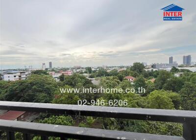 Balcony view of the city with surrounding greenery