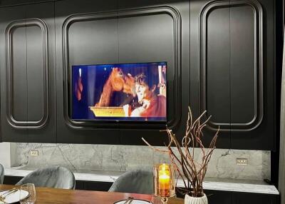 Modern dining area with TV and decorative elements