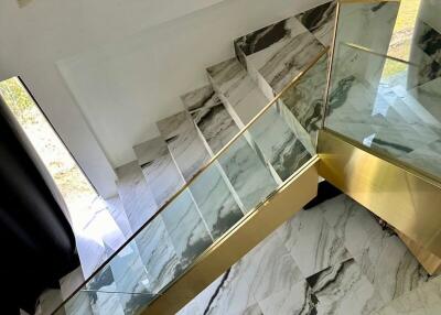 Elegant marble staircase with glass railing