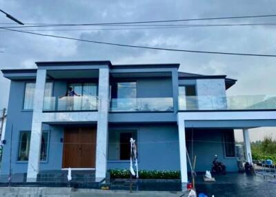 Modern two-story house with a balcony and a garage