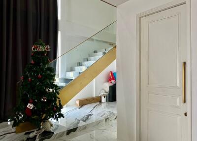 Living space with Christmas tree and staircase