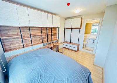 Modern bedroom with built-in wooden wardrobe and ensuite bathroom