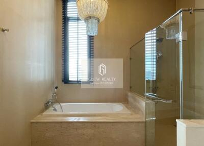 Bathroom with bathtub and glass shower enclosure