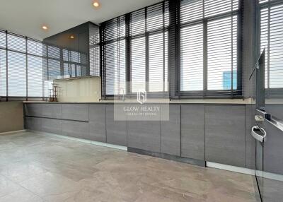 Modern kitchen with large windows and sleek cabinetry