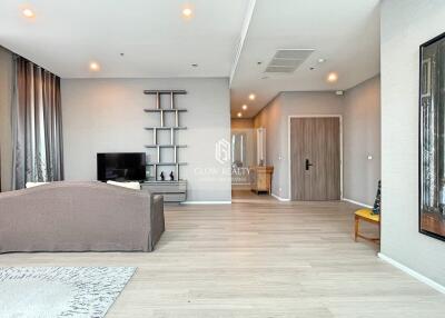 Modern living room with a TV, sofa, and wooden flooring