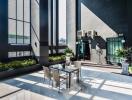 Modern outdoor terrace with table and chairs, potted plants, and tall building