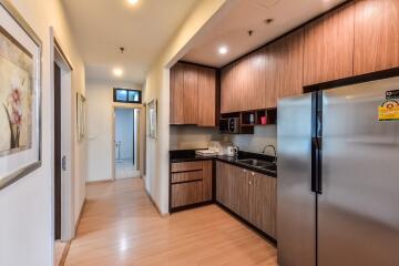 Modern kitchen with wooden cabinets and stainless steel appliances