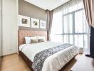 Modern bedroom with a large window, wooden floor, and soft toned decor.