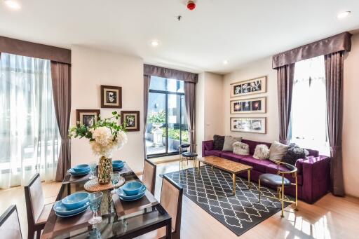 Modern living room with dining area and large windows