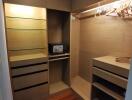 Spacious closet with built-in shelves and hangers