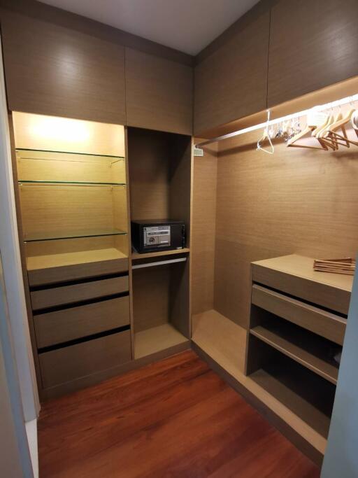 Spacious closet with built-in shelves and hangers