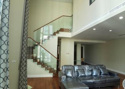 Spacious double-height living room with modern staircase