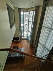 Spacious living room with floor-to-ceiling windows and city view