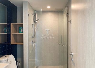 Modern bathroom with glass shower and shelving