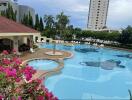 Resort-style outdoor swimming pool with floral decoration and lounge chairs