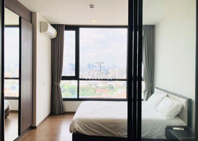 modern bedroom with large window and city view