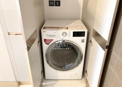 Laundry area with a 2-in-1 washing machine and dryer