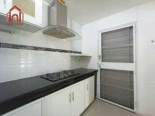 Modern kitchen with stove and ventilation hood