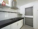 Modern kitchen with stove and ventilation hood