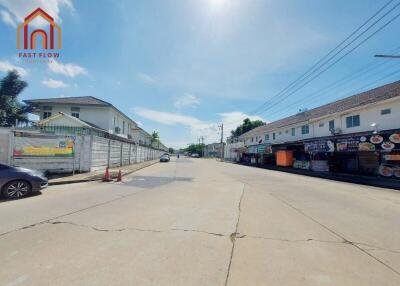 Street view featuring residential buildings and local shops