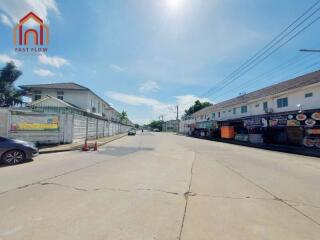 Street view featuring residential buildings and local shops