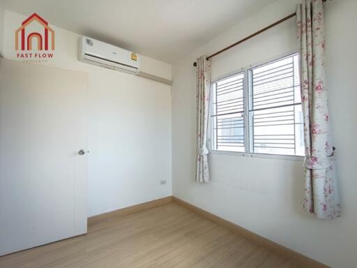 Small bedroom with air conditioner and window