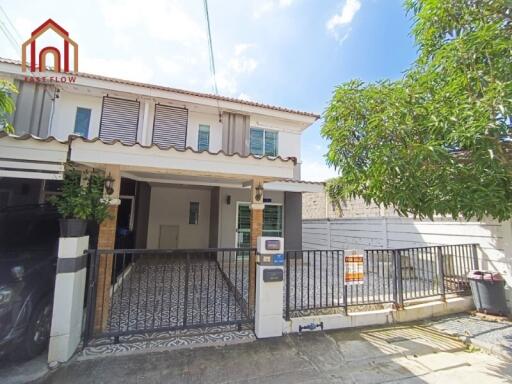 Front view of a residential house with parking area