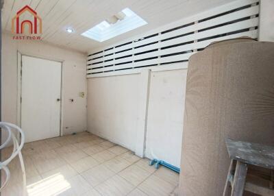 Utility room with tiled flooring and skylights