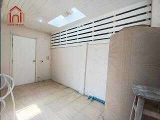 Utility room with tiled flooring and skylights