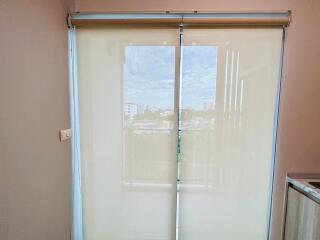 Window with roller blinds and a view outside