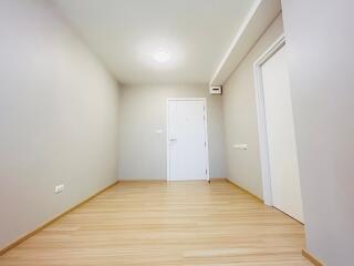 Spacious empty living room with wooden flooring