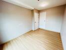 Empty bedroom with wooden flooring