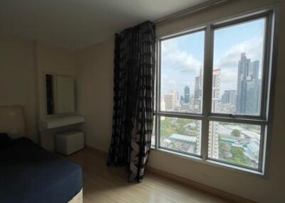 Modern bedroom with large window and city view